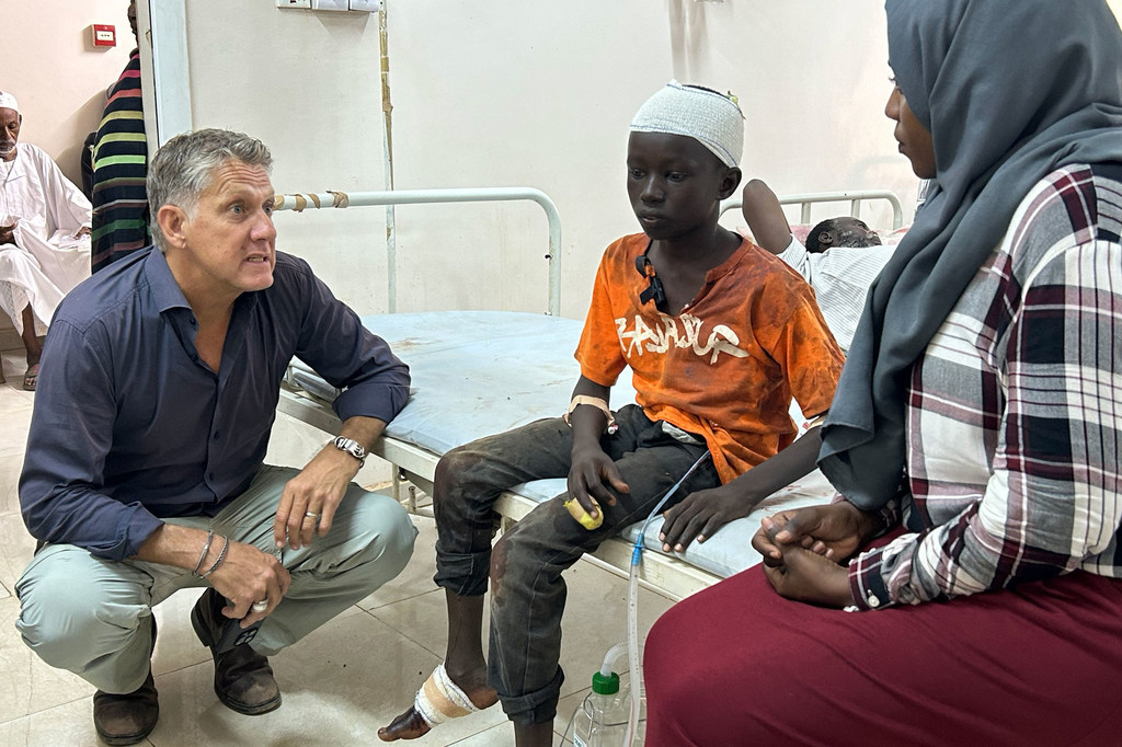 UNICEF Spokesperson James Elder speaks to 13-year-old Abu at Al Nao hospital in Khartoum, Sudan.